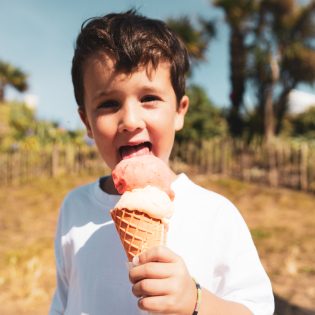 Un petit garçon savoure une glace sur la digue de l'écluse à dinard